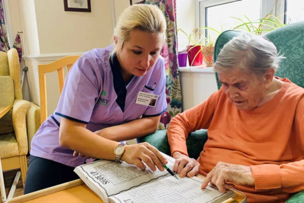 Staff member engaging in memory activities with a resident